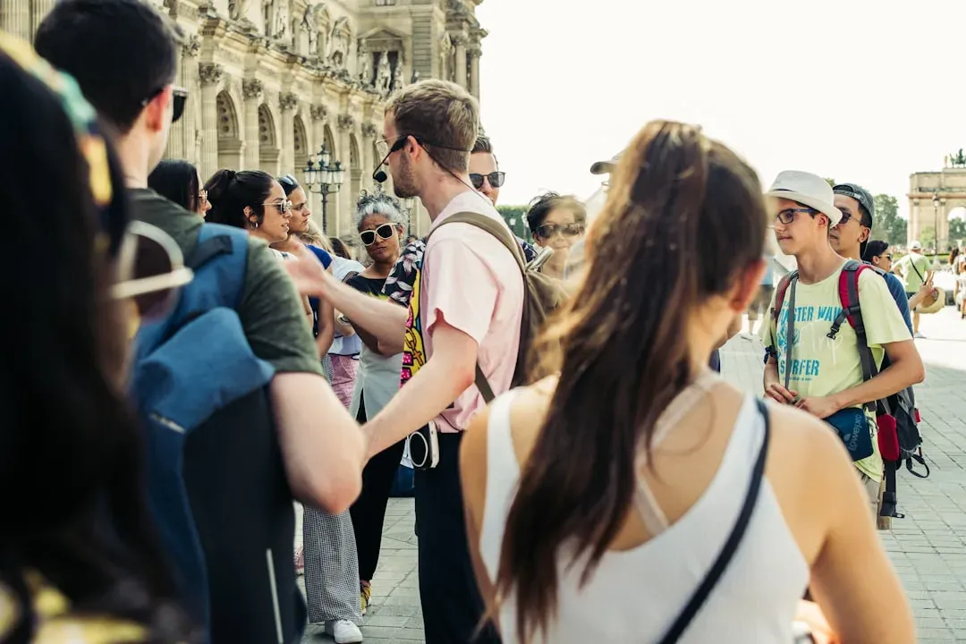 tour guide with group of tourists, 8-14 words, includes primary keyword naturally