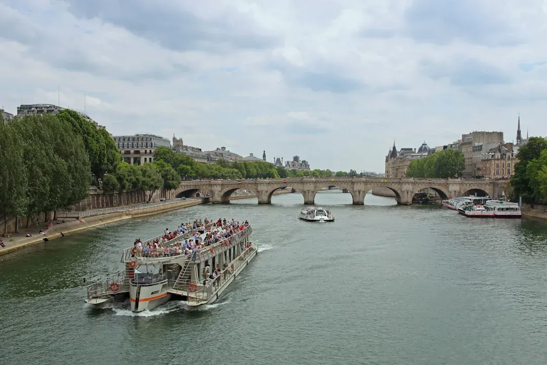 Seine River Cruise boat in Paris with Eiffel Tower in the background