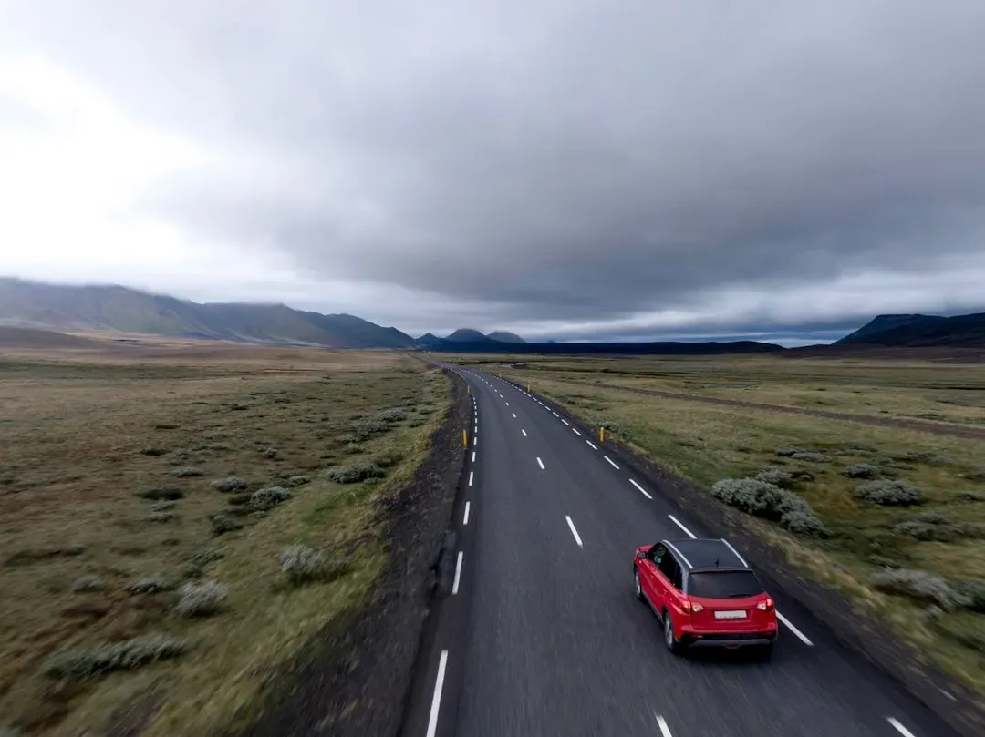 car driving on road, 8-14 words, includes primary keyword naturally